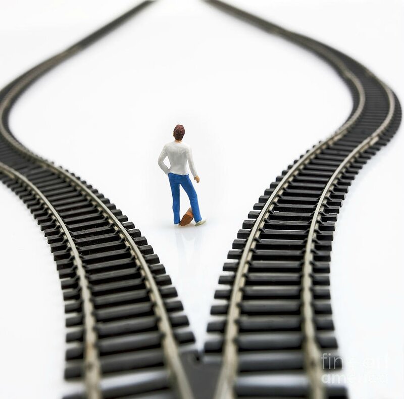 3-figurine-between-two-tracks-leading-into-different-directions-symbolic-image-for-making-decisions-bernard-jaubert