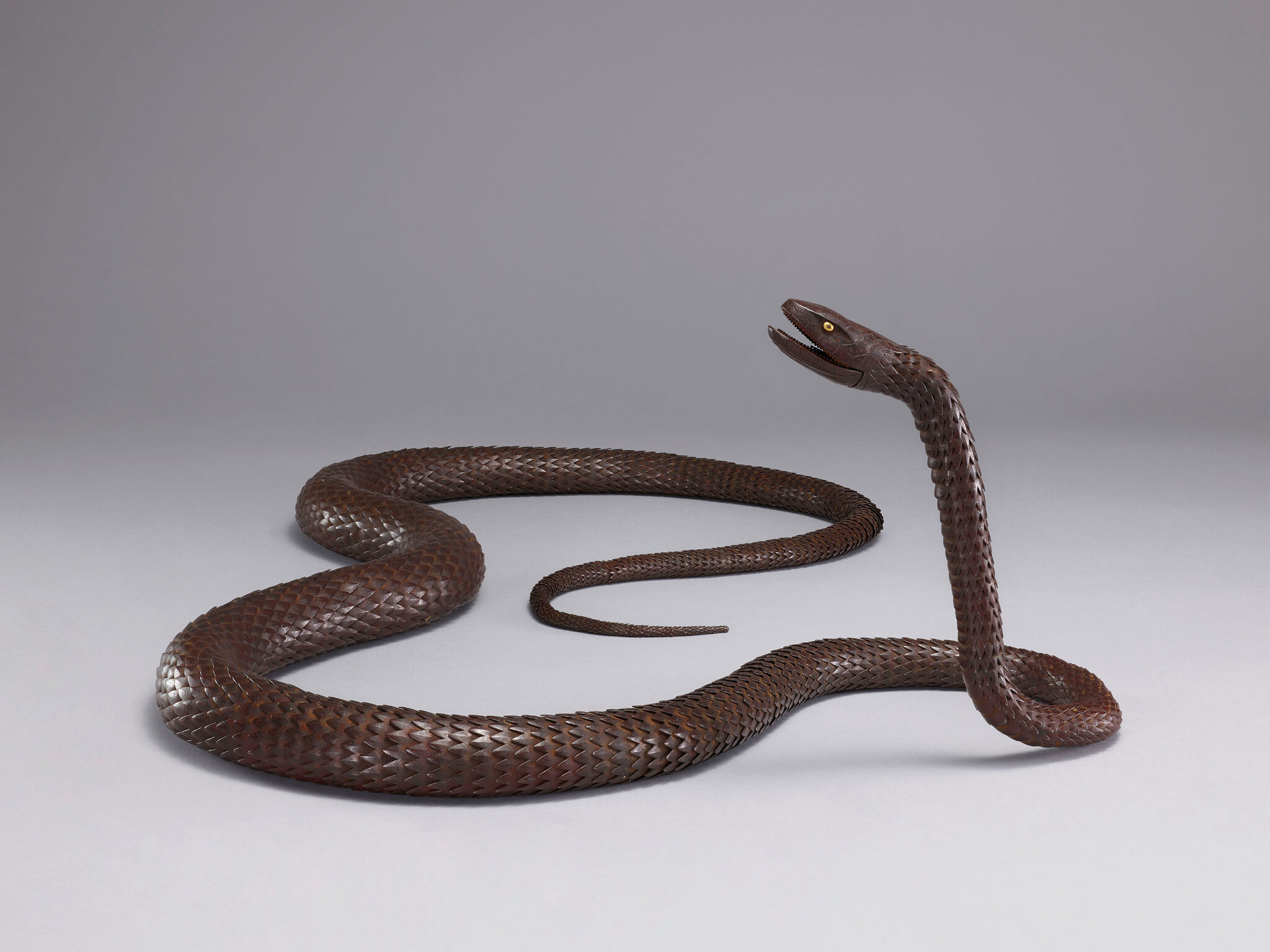 An iron articulated sculpture of a long snake, Early 20th