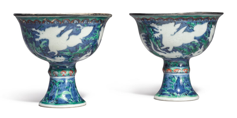 An extremely rare pair of blue-ground iron-red and green-enameled 'Mythical beasts' stem cups , Wanli marks and period (1573-1619)