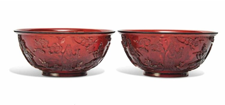 A pair of Chinese red glass 'Immortals' bowls, 19th-20th century