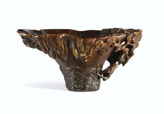 A large rhinoceros horn 'Pine and River' libation cup, Qing dynasty, 17-18th century