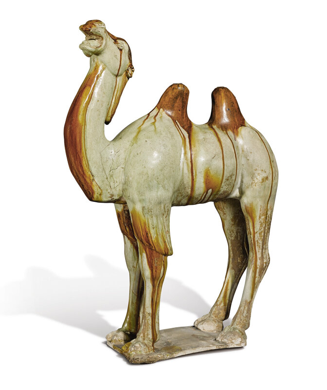 An amber and straw-glazed pottery figure of a camel, Tang dynasty (618-907)