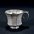 A silver 'flowers and <b>bird</b>' octogonal cup with handle, Tang dynasty (618-907)
