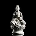 A <b>celadon</b>-<b>glazed</b> <b>porcelain</b> figure of Quan Am seated atop a lotus base, North Vietnam, 18th-19th ct