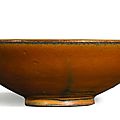 A 'Yaozhou' <b>persimmon</b>-<b>glazed</b> gilt-decorated conical bowl, Northern Song dynasty (960-1127)