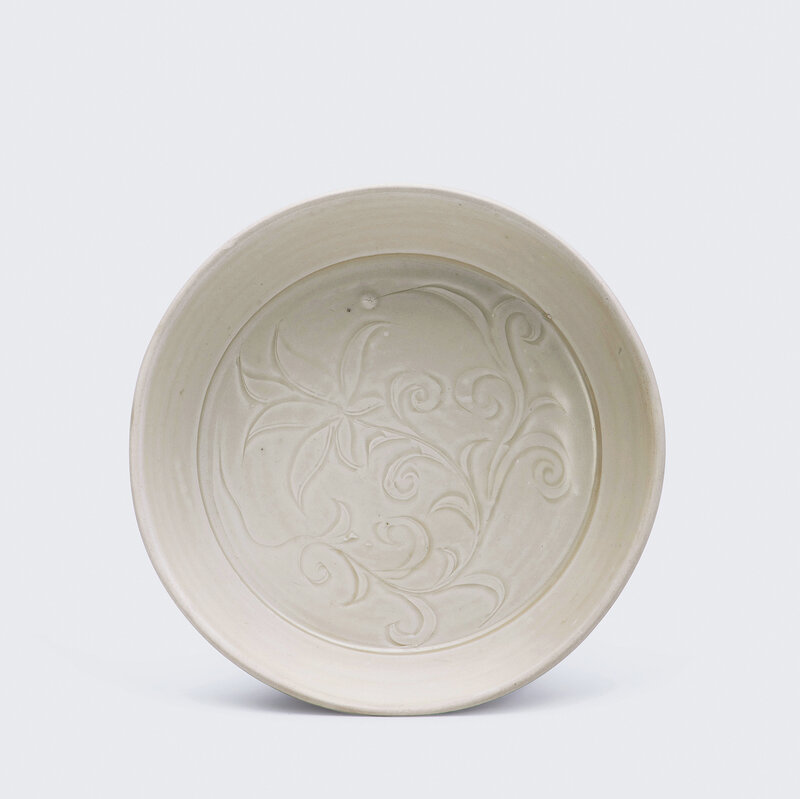 A carved Ding white-glazed 'Daylily' washer, Northern Song dynasty (AD 960-1127)