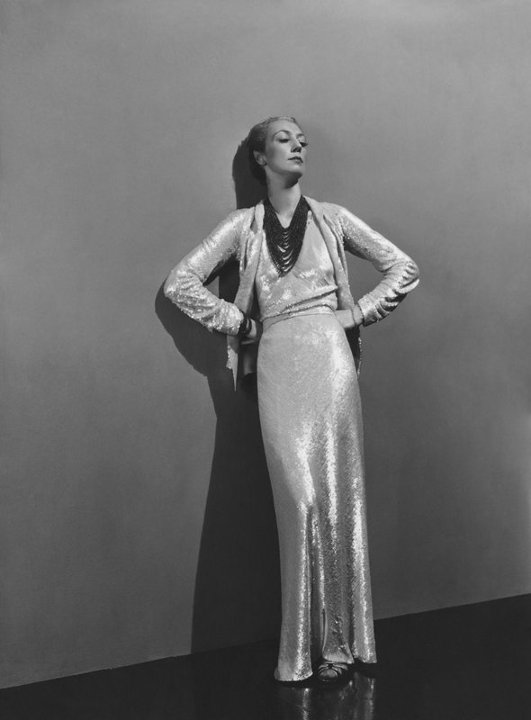 Roussy Sert wearing a long white sequin dress by Chanel, and a 15-strand coral necklace, Photograph by André Durst, published in Vogue December 15, 1936