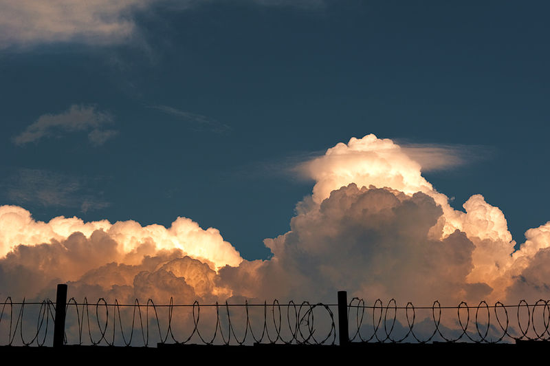 razor_wire_and_clouds