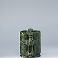 A carved spinach-green jade '<b>champion</b> <b>vase</b>', the <b>vase</b> Ming dynasty (1368-1644), with a Qianlong incised mark and period