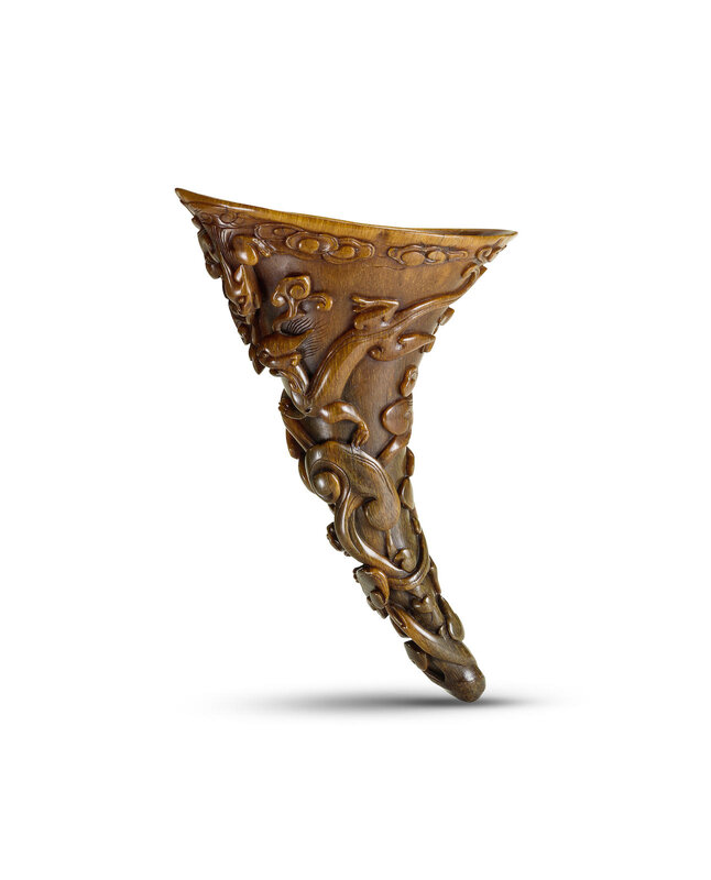 A carved 'chi dragon and clouds' rhinoceros horn libation cup, 17th century