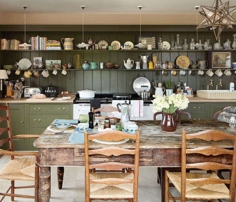 rita-konig-kitchen-plain-english-green-cabinets-white-aga-stove-rush-seats-country-house-england-farmhouse-elle-decor-june-2019