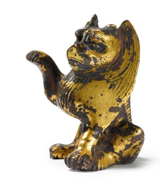 A rare small Chinese gilt-bronze figure of a seated lion, Northern Wei-Tang dynasty, 6th-7th Century