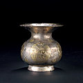 A parcel gilt-decorated silver 'floral' spittoon, Tang dynasty, 7th-<b>10th</b> <b>century</b>