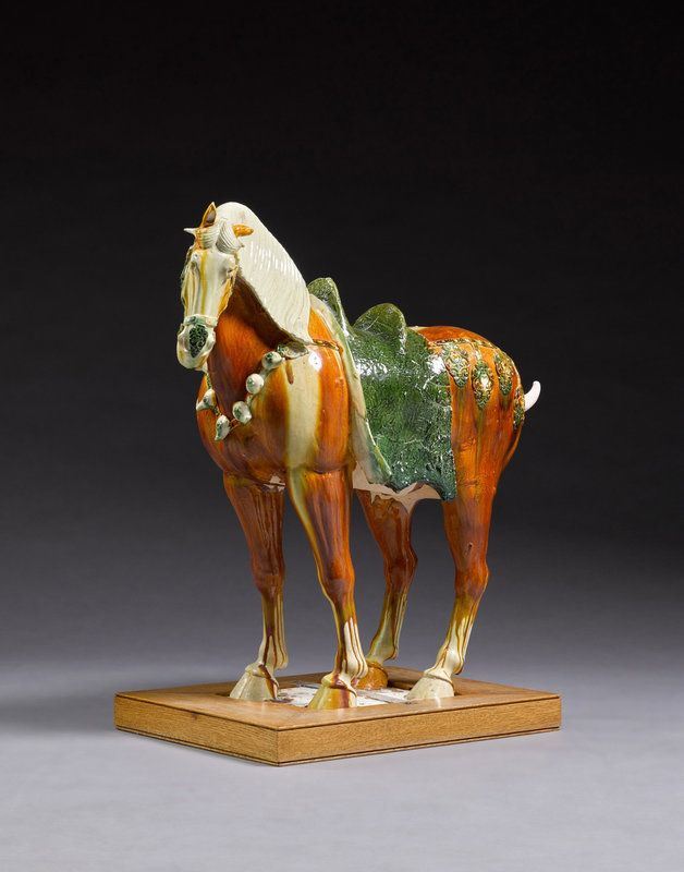 A magnificent large sancai-glazed figure of a caparisoned Fereghan horse, Tang dynasty