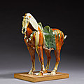 A magnificent large <b>sancai</b>-glazed figure of a caparisoned Fereghan horse, Tang dynasty (618-907)