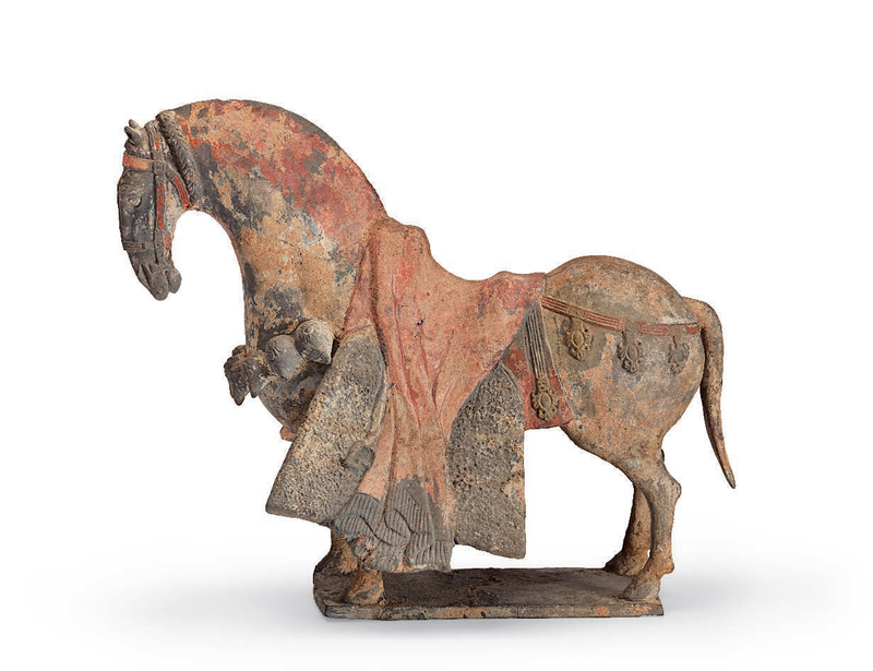 A painted grey pottery figure of a caparisoned horse, Northern Wei dynasty (AD 386-534)