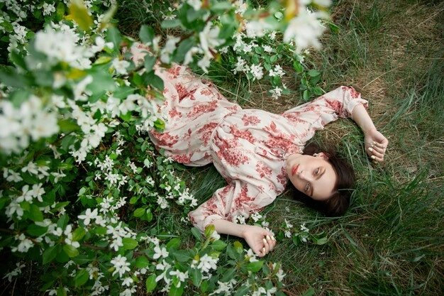 beautiful-young-woman-lies-grass-blooming-apple-tree-romantic-girl-is-resting-nature-spring-portrait-woman_91497-6512