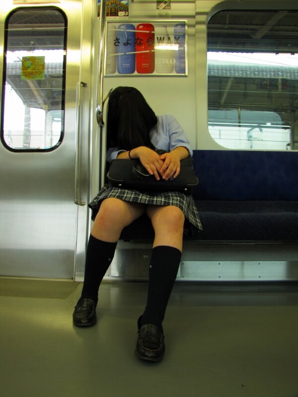 Sleeping school girl face to skirt