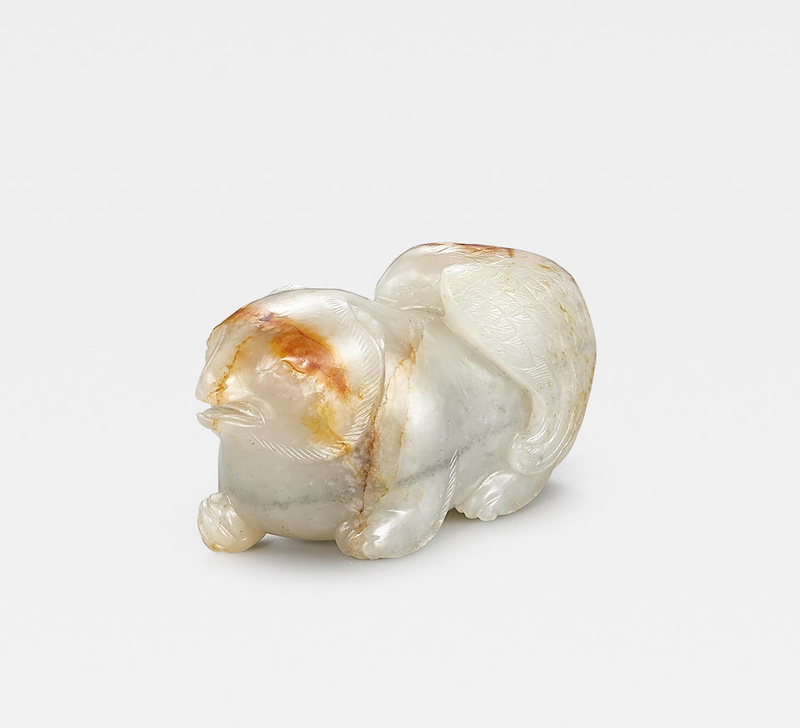 An exceptionally rare white and russet jade 'eagle and bear' group, Ming Dynasty or earlier