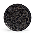 A carved black lacquer <b>circular</b> <b>dish</b>, China, Yuan-early Ming dynasty, 14th century
