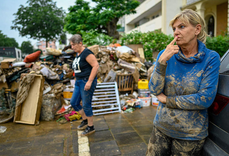 Flood-victims-stand-dejected-outside-their-damaged-homes-in-Germany-PhotoThe-Economic-Times