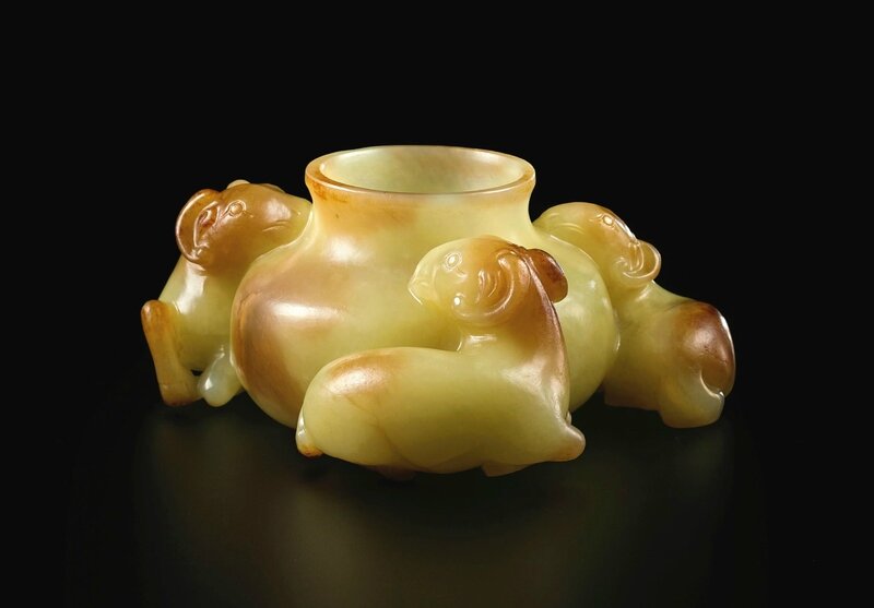 A superbly carved yellow and russet jade 'three rams' waterpot, Qing dynasty, 18th century