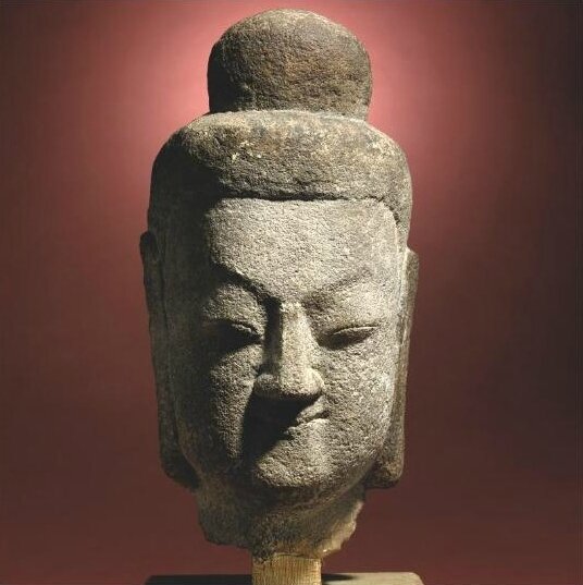 A rare sandstone head of a Buddha, Northern Wei dynasty