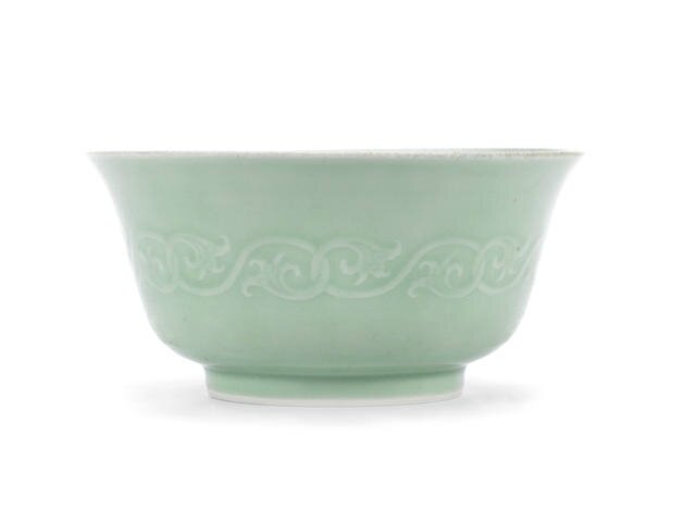 A carved celadon-glazed bowl, Yongzheng six-character mark and possibly of the period