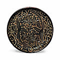 A small carved black lacquer <b>circular</b> <b>dish</b>, Yuan dynasty (1279-1368)