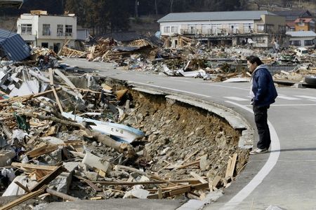 73958_a_man_looks_at_the_damage_caused_by_the_earthquake_and_tsunami_in_ofun