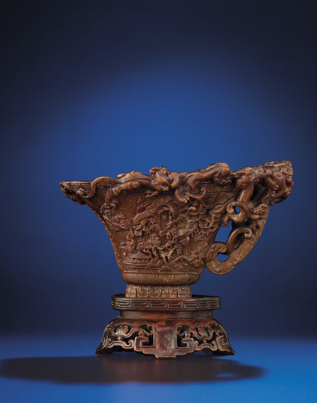 A rare and finely carved 'Nine dragons' rhinoceros horn libation cup, Ming dynasty, early 17th century 