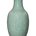 A large moulded and carved celadon-glazed ‘lotus’ vase, <b>Qianlong</b> <b>period</b> (1736-1795)
