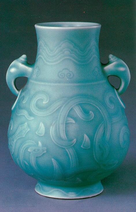 A moulded celadon-glazed pear-shaped archaistic 'dragon' vase, Yongzheng six-character seal mark in underglaze blue and of the period (1723-1735)