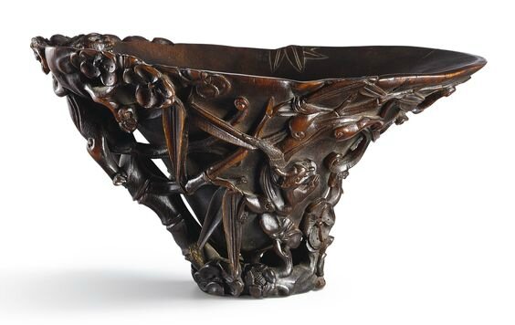 A carved rhinoceros horn 'chilong, prunus and bamboo' libation cup, 17th century