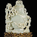 A large white jade 'prunus and <b>lingzhi</b>' vase and cover, Qing dynasty, Qianlong period