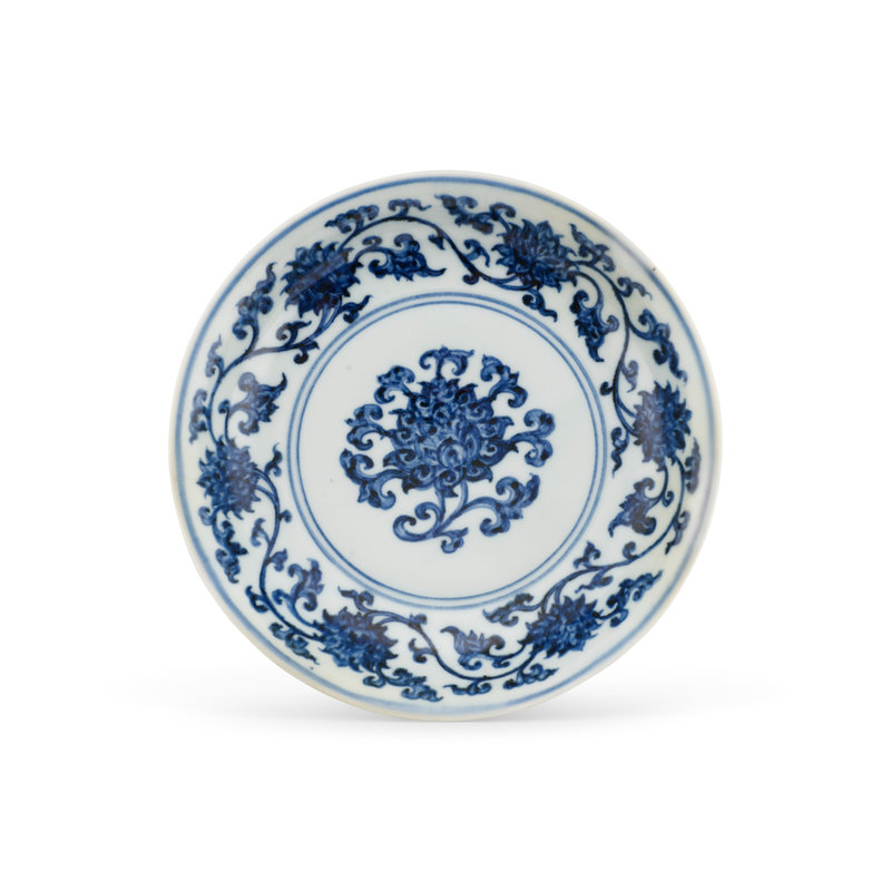 A rare small blue and white ‘lotus’ dish, Xuande six-character mark in underglaze blue within a double circle and of the period (1426-1435)