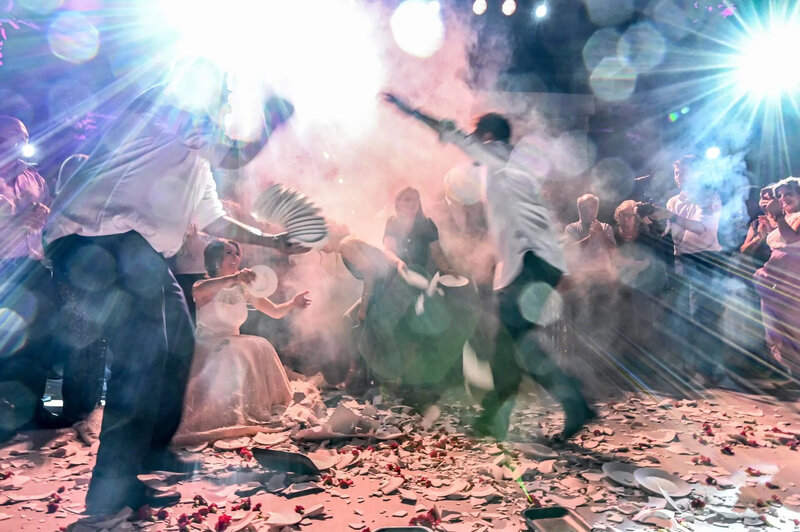 Athens, Greece People dance to traditional Greek music amid broken plates during a wedding celebration in Athens