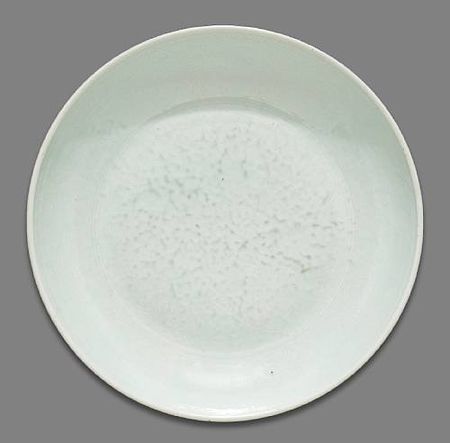 A_white_glazed_porcelain_deep_dish_with_incised_floral_decoration