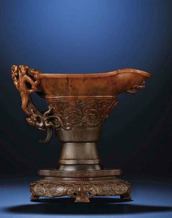 An exquisitely carved archaistic 'chilong' rhinoceros horn libation cup, Ming dynasty, early 17th century 