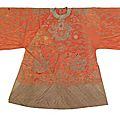 A red-ground <b>silk</b> jacket with dragon motif & An embroidered red-ground satin <b>silk</b> <b>robe</b> with blue flower design, China, late Qing