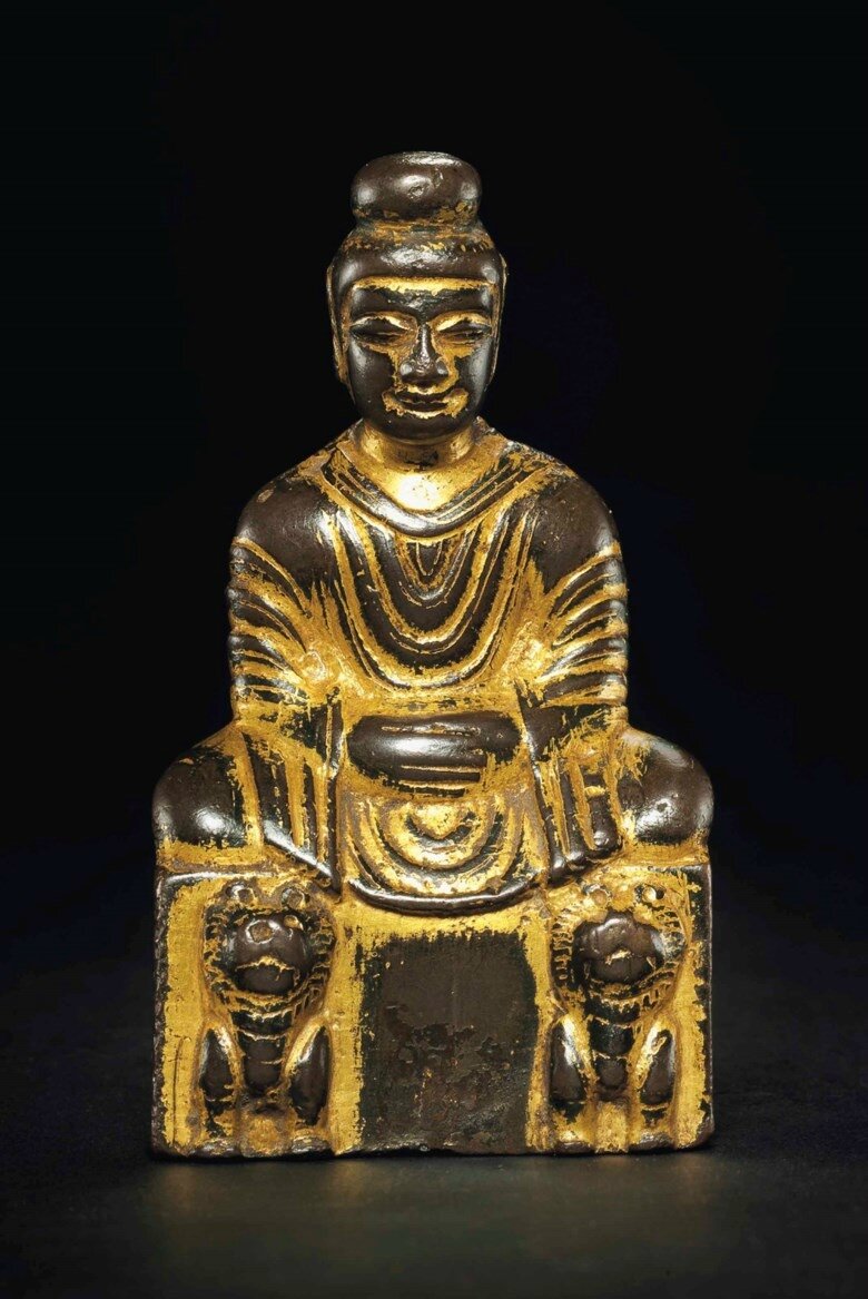A small gilt-bronze figure of Shakyamuni Buddha, Sixteen