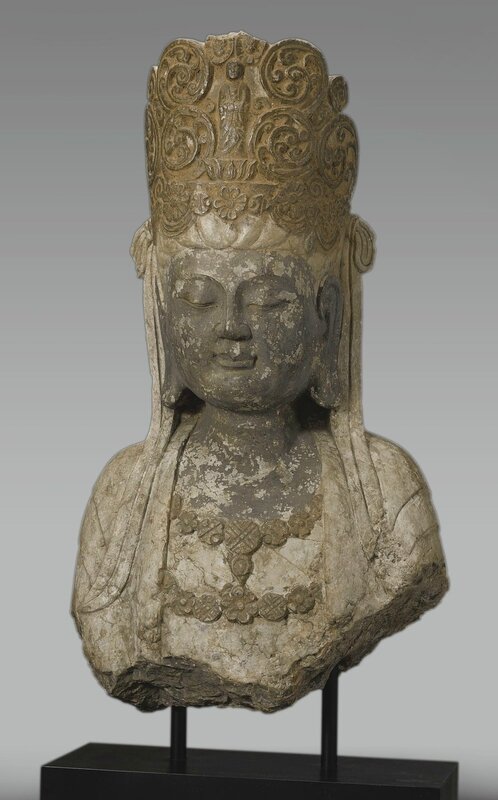 A large stone bust of Avalokiteshvara
