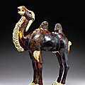 A <b>chestnut</b> <b>and</b> <b>straw</b>-<b>glazed</b> <b>pottery</b> figure of a Bactrian camel, Tang dynasty (AD 618-907)