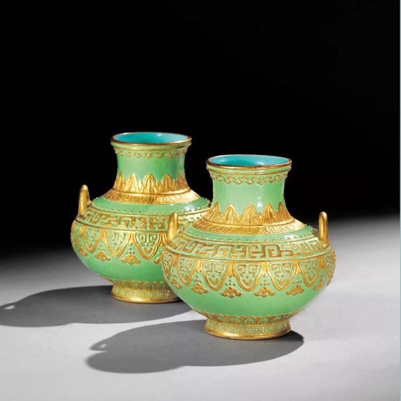 An exceptionally rare pair of gilt-decorated and enamelled vases, Qianlong moulded and gilt six-character seal marks and of the period (1736-1795)