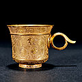 A <b>gold</b> 'floral' cup with handle, Tang dynasty (618-907)