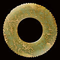 A green jade notched disc, bi, Neolithic period, Jiang-Huai region