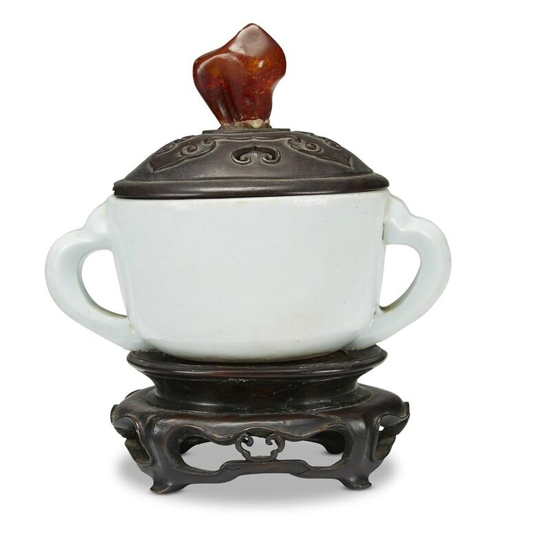 A Korean porcelain twin-handled cup, with carved wood cover, amber finial, The cup 18th-19th century