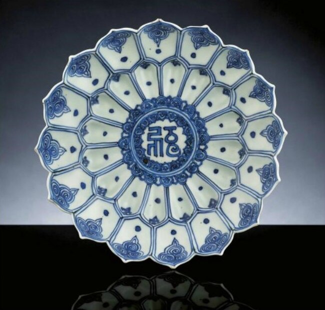 A late Ming blue and white moulded 'Lotus' dish, Wanli six-character mark within double circles and of the period (1573-1619)