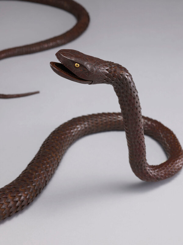 An iron articulated sculpture of a long snake, Early 20th An iron articulated sculpture of a long snake, Early 20th