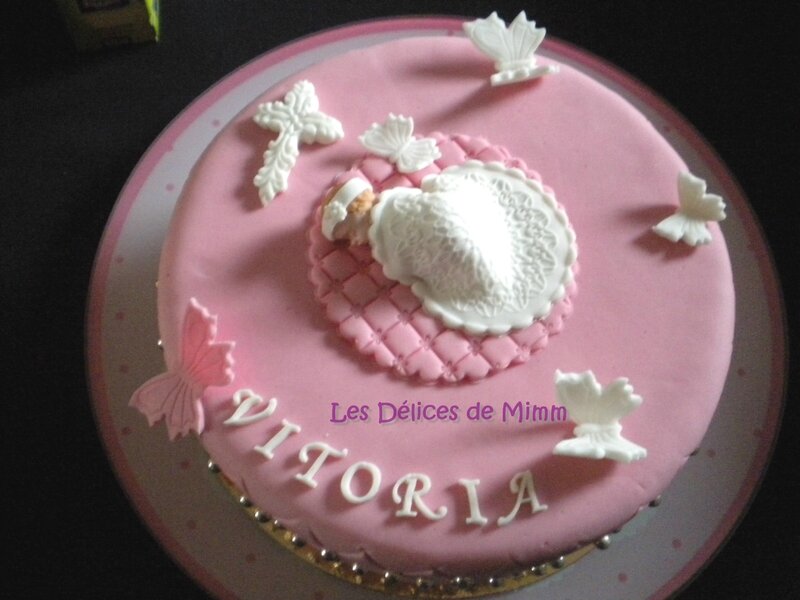 Un gâteau de baptême rose avec des papillons 7